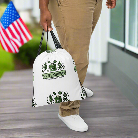 white eco-friendly bag with ‘Vote Green, It’s the Natural Choice’ slogan, standing on a porch with an American flag in the background, promoting environmental awareness and green voting initiatives